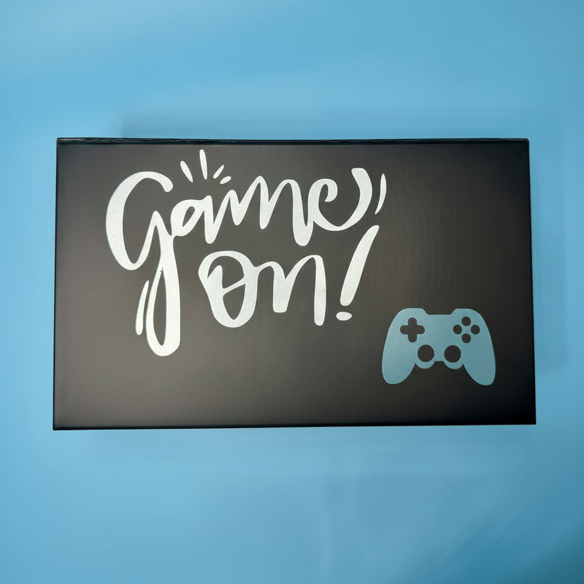 Personalized Black box with 'Game On!' text and a gaming controller icon on a blue background