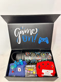 Gaming-themed gift set with 'Game On!' text on a box