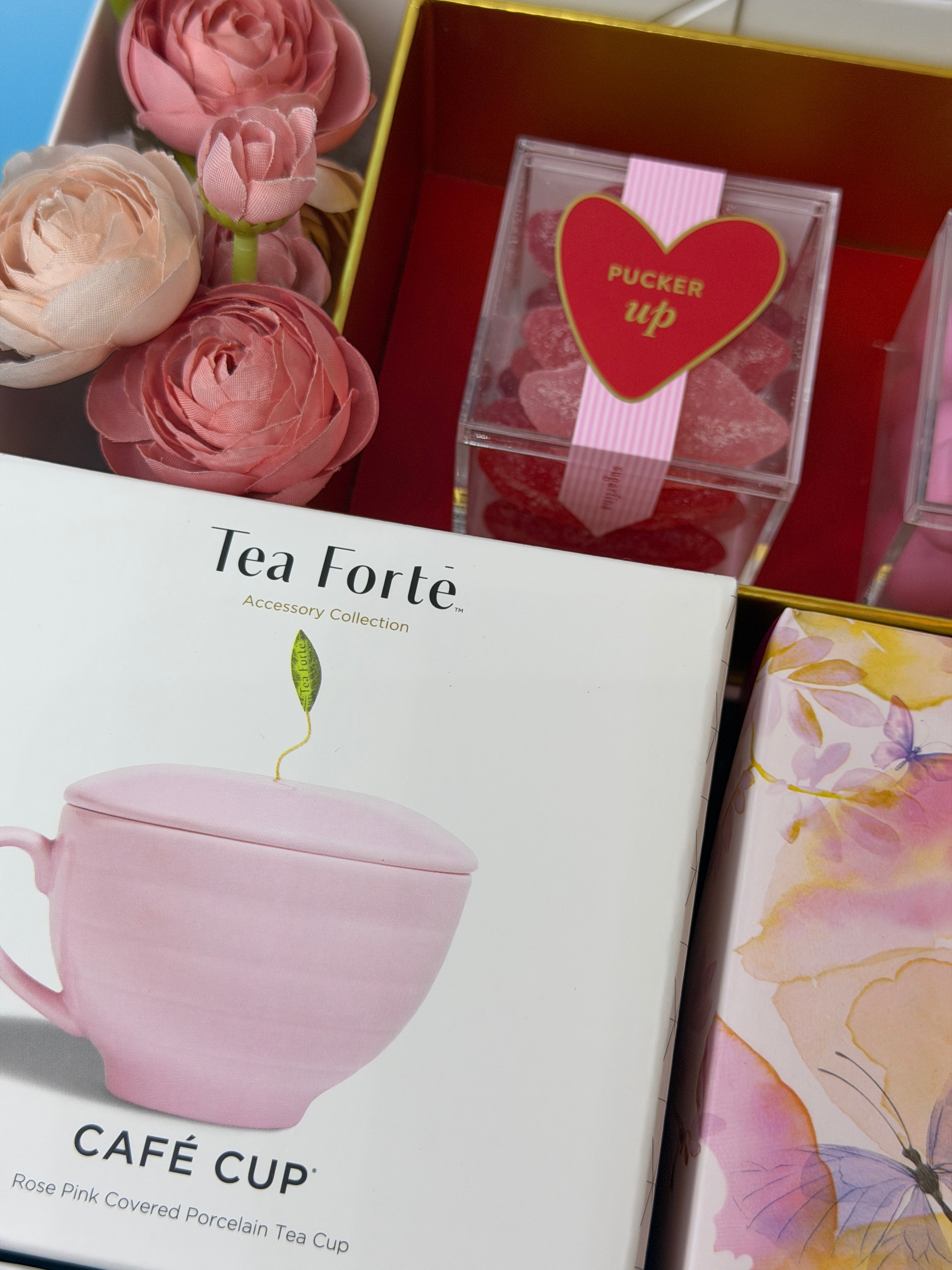 Gift Box with a pink tea forte CUP and floral design in the background