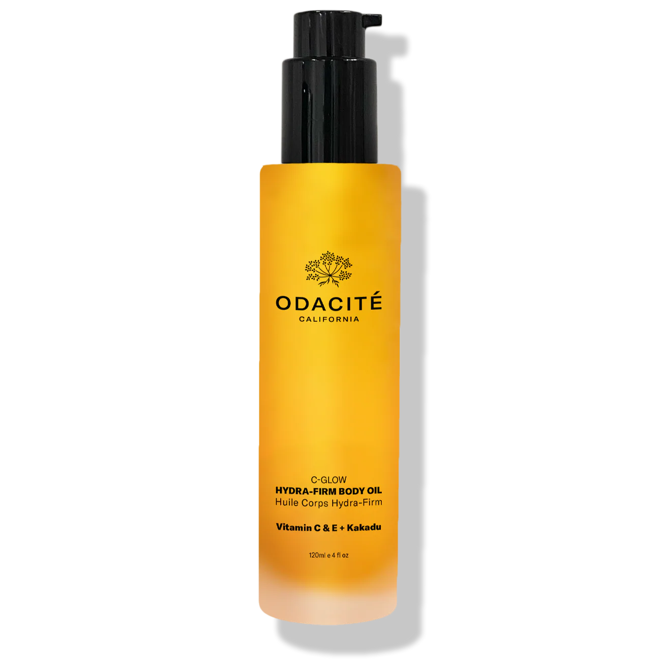 Yellow bottle of Odacite body oil with black pump on a white background