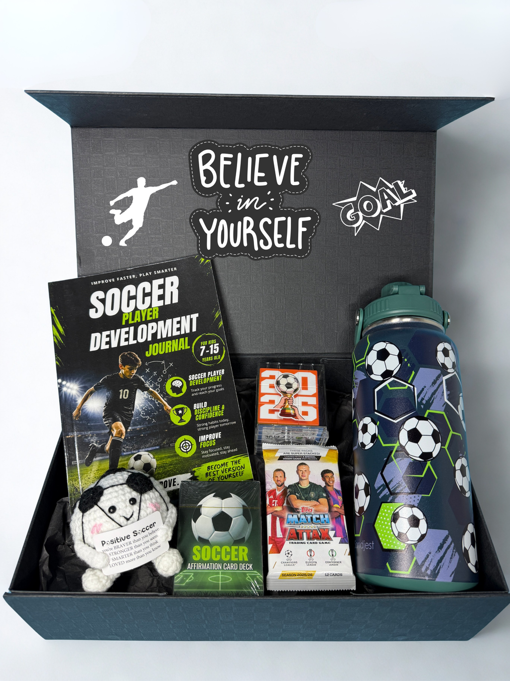Soccer-themed gift set with a water bottle, Soccer development journal, soccer trade cards, and other soccer-themed items in a black personalized box.