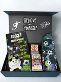 Soccer-themed gift set with a water bottle, Soccer development journal, soccer trade cards, and other soccer-themed items in a black personalized box.